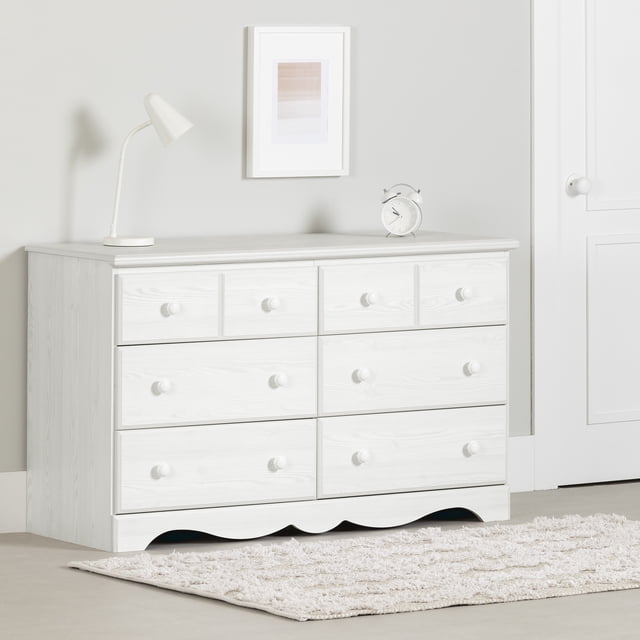 South Shore Summer Breeze 6-Drawer Dresser for Child in white pine finish, featuring six spacious drawers with round knobs and metal slides in a traditional style, shown in a child’s room with a white lamp and alarm clock on top, placed on a beige floor with a cream textured rug.