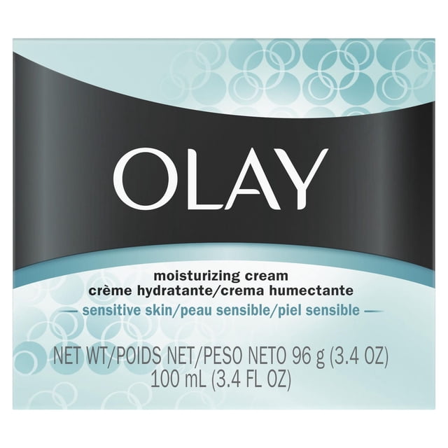 Olay Moisturizing Sensitive Skin Cream packaging with a black and light blue design, featuring the brand name Olay in large white letters on a black curved background, and product details in English, French, and Spanish stating it is a moisturizing cream for sensitive skin that restores hydration and supports the skin’s moisture barrier, with a net weight of 96 g (3.4 oz) and volume of 100 mL (3.4 fl oz).