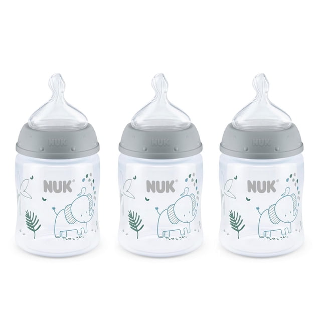 NUK Smooth Flow Anti-Colic Bottle set of three clear baby bottles with gray caps and silicone nipples, each decorated with a blue elephant and green leaf design, featuring an anti-colic nipple that adjusts flow rate and SafeTemp temperature indicator for safe feeding.