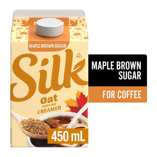 Silk Oat Coffee Creamer Maple Brown Sugar 450ml carton with beige and orange maple leaf design, featuring a wooden spoon with brown sugar and a coffee cup with swirling creamer, dairy-free plant-based non-dairy creamer ideal for coffee and suitable for adding to tea.