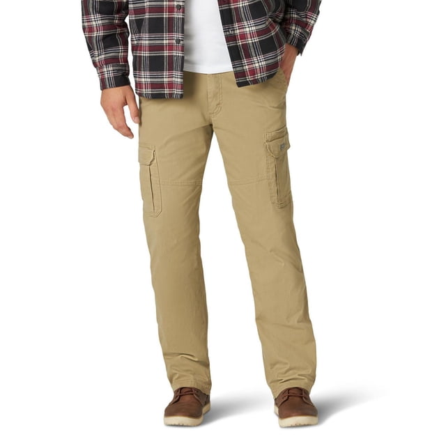 Wrangler Men's Twill Cargo Pant in tan with relaxed fit and straight leg, featuring stretch twill fabric, multiple flap cargo pockets, and reinforced stitching, shown front-facing on a model wearing brown shoes and a plaid shirt, suitable for outdoor and work use.