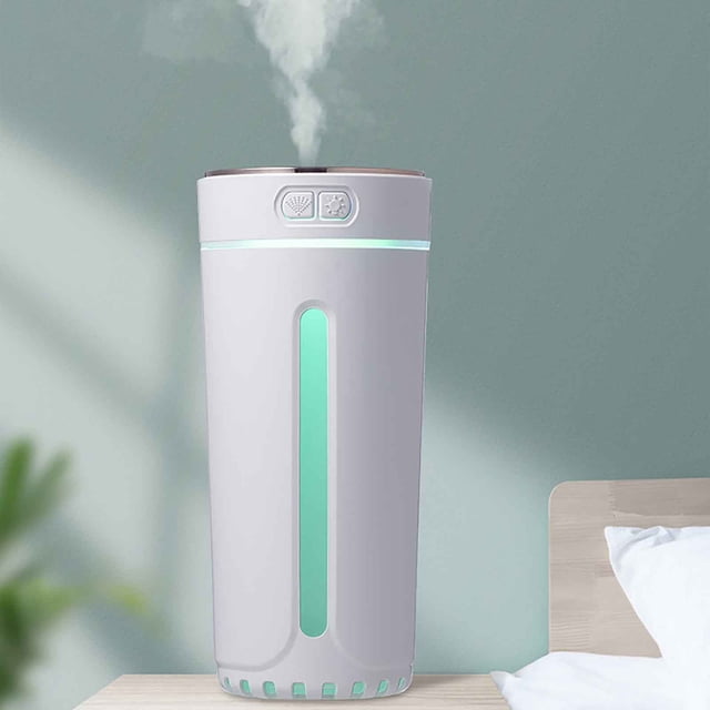 Small Silent Portable USB Car Aromatherapy Humidifier Phantom Cup Colorful Night Humidifier with a sleek white design, glowing green LED light, and steam emitting from the top. Ideal for use in cars, bedrooms, or offices, it features a 300ml capacity, two spray modes, and automatic shutdown for safety. Compact and portable, suitable as a desk humidifier.