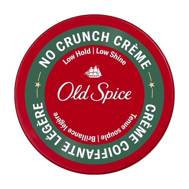 Old Spice Hair Styling Crème for Men in a round red container with a green circular label on the lid stating 'No Crunch Crème' and 'Low Hold | Low Shine'. The label features the Old Spice logo with a sailing ship icon and includes 'Tenable Souple | Brillance Légère'. This men's hair cream offers flexible hold and a low-shine finish for effortless styling.