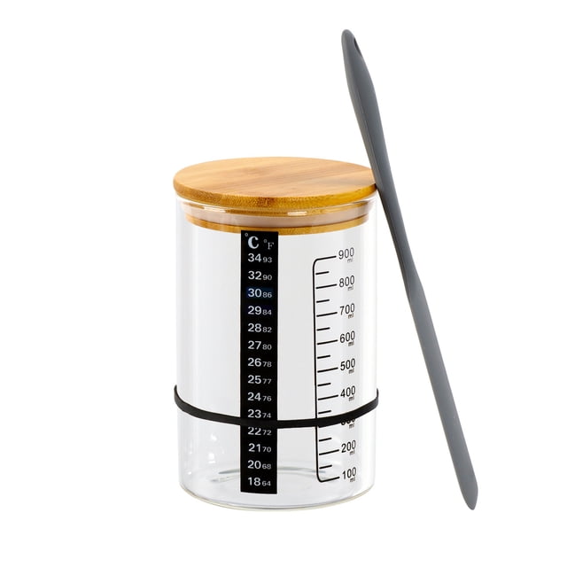 EGNMCR Glass Jars With Graduated Scale High Temperature Fermentation Dishes Fermentation Jars For Natural Yeasts. A clear glass jar with a wide mouth, featuring a graduated scale for precise measurements, a wooden lid, and a temperature strip for monitoring fermentation. Includes a grey spatula for stirring and a black elastic band for securing the fabric cover during fermentation. Suitable for sourdough starters, natural yeast fermentation, and food storage.