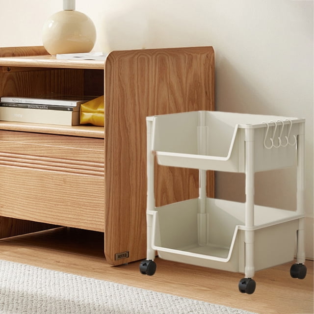 Matoen Rolling Storage Trolley Laundry Room Organization 2 Tier Mobile Shelving Unit Bathroom Organizer. A white plastic trolley with two adjustable tiers, side hooks for added storage, and four 360° rotating wheels for smooth movement. Shown in a home setting next to a wooden cabinet, suitable for organizing items in bathrooms, kitchens, or laundry rooms.