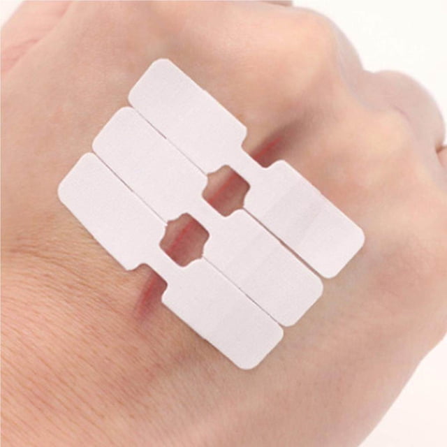 10Pcs/Box Waterproof Band Aid Butterfly Adhesive Wound Closure Bandages shown applied on the back of a hand. The bandages are made of waterproof cloth, designed for wound-free stitching, and feature a breathable, non-stick surface. Each bandage measures 45 x 10mm and is suitable for hemostasis and wound care. The image highlights the butterfly adhesive design for secure application.