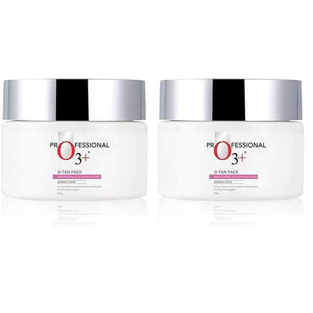 O3+ D-TAN Professional Pack for instant tan removal, suitable for all skin types, 50g. The image shows two white jars with silver lids, labeled 'Professional O3+ D-TAN Pack Brightening & Glow Boosting.' This pack is designed to remove stubborn tan, even skin tone, and deeply cleanse pores. Enriched with lactic acid, pea extract, and mint for a soothing and nourishing effect.