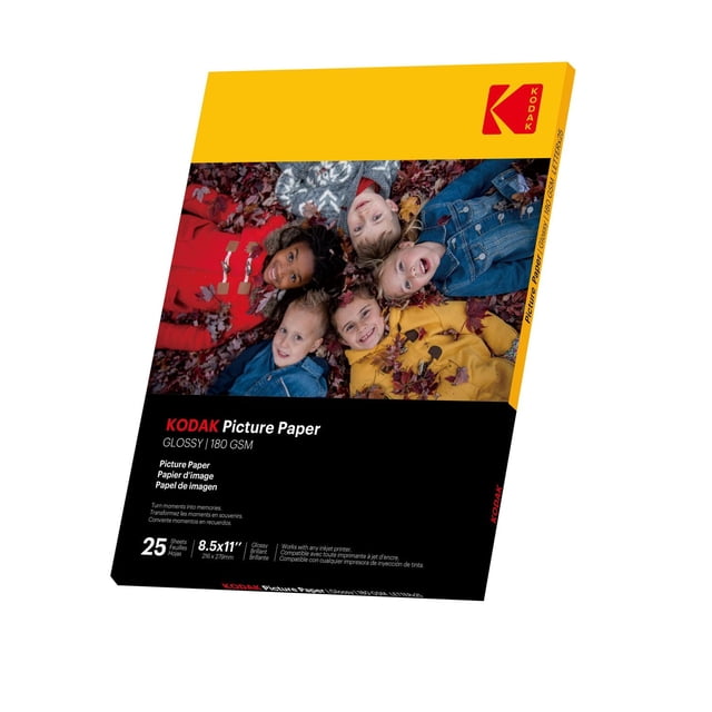 Kodak Picture Paper glossy 180 GSM pack with 25 sheets of 8.5 x 11 inch photo paper, showing a cover image of people lying on autumn leaves wearing red, yellow, and denim jackets. Compatible with all inkjet printers for high-quality photo printing.
