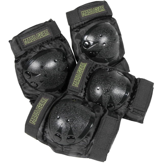 Madd Gear Jr Elbow and Knee Pads Set with four black protective pads featuring abrasion-resistant hard shells, soft EVA foam padding, and adjustable nylon velcro straps for a secure fit, designed for kids 5 years and up learning to scoot, skate, or inline skate safely.
