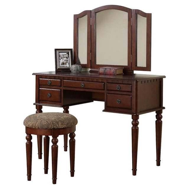 Poundex Furniture Wood Vanity Set with Mirror and Stool in Cherry Color. This set includes a vanity desk with a tri-fold mirror, five storage drawers with round metal pulls, and a matching upholstered stool with a padded seat and round-tapered legs. Made from solid rubberwood, manufactured wood, and birch veneers, the set features turned legs and a cherry finish. Dimensions: Vanity desk 54 inches high, 43 inches wide, and 19 inches deep; stool 19 inches high with a 19-inch diameter. Assembly required.