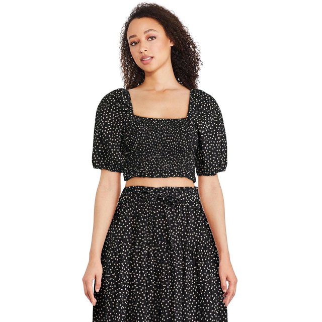 George Women's Smocked Bodice Top in black with white polka dots, featuring a square neckline, short puff sleeves with elasticized cuffs, a smocked bodice, and a ruffled hem, worn front-facing by a model paired with a matching skirt, suitable for casual or dressy occasions.