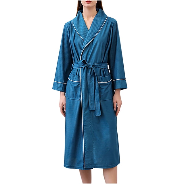 Timegard Womens Sleepwear Plus Size Long Sleeve Robe in a mid-length design, shown in a textured blue fabric with white piping accents. The robe features a belted waist, two front pockets, and a classic shawl collar. Made from lightweight, breathable, and soft fabric, it is ideal for lounging or sleeping. Suitable for casual and daily wear, this robe offers a relaxed fit for comfort.