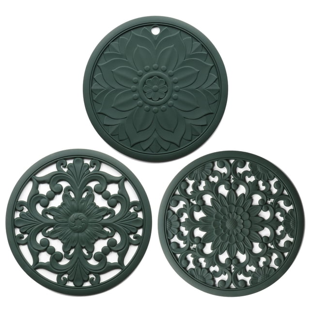 Silicone Trivets for Hot Pots and Pans Silicone Trivet Mat Set with 3 Carved Patterns. The set includes three round, dark green silicone mats with intricate carved designs, offering heat resistance up to 482°F. Each mat measures 7.87 inches in diameter and 0.21 inches thick, suitable for protecting countertops and tables from hot pots, pans, and dishes. The non-slip, food-grade silicone material is BPA-free, soft, and flexible, ensuring durability and safety. These trivets are easy to clean, either by hand or in the dishwasher, and can also be used as jar openers, spoon rests, or decorative table mats.