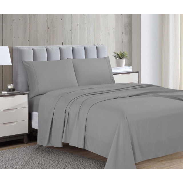 1800 Series Microfiber Sheet Set in grey on a bed with a light grey tufted headboard, featuring a flat sheet, fully elasticized fitted sheet, and two pillowcases made from double brushed microfiber fabric for softness, wrinkle resistance, and durability, displayed in a bedroom with wood panel wall, white curtains, and bedside tables with lamp and plant.