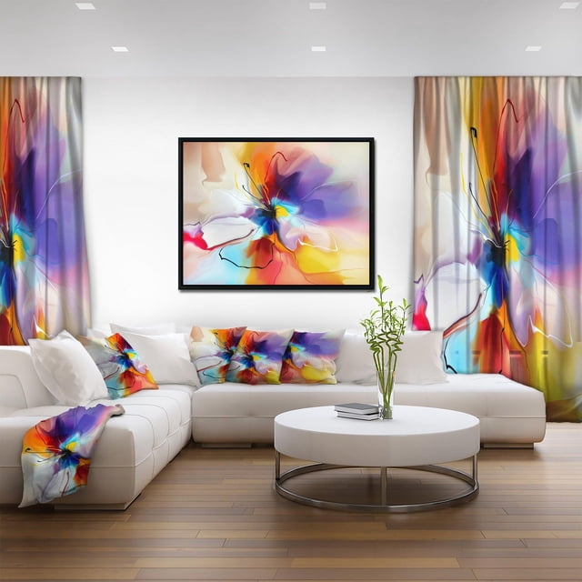 Designart Fleur Créative en Plusieurs Couleurs Cadre Flottant ART Mural avec un design floral Abstrait Multicolore dans des Tons Violet, Bleu, Jaune, orange et Rouge sur Toile de Coton de Qualité Supérieure avec un Cadre Flottant Noir. la Toile Enveloppée de Galerie Se Suspend sur un Mur Blanc au-Dessus d'Un sofa Sectionnel Blanc avec Coussins Décoratifs Floraux Assortis et Rideaux dans un Salon Moderne. une table Basse Ronde Blanche avec une base en Métal et une Petite Plante Verte Complètent le décor Contemporain.