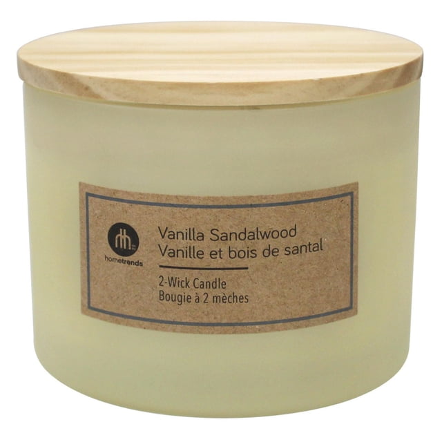 Hometrends 12oz Vanilla Sandalwood Scented 2-Wick Frosted Jar Candle in ivory frosted glass with a wooden lid and brown label, designed for indoor Christmas decoration and filling rooms with warm fragrance.
