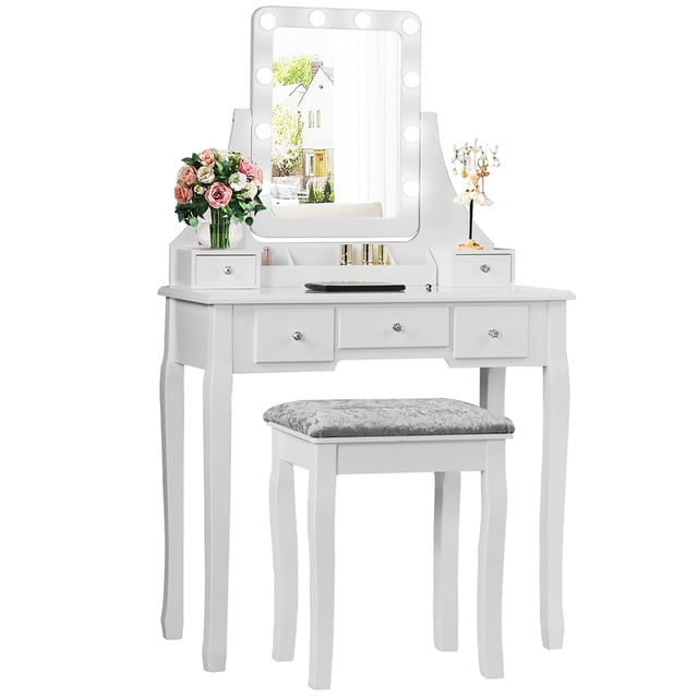 Costway Vanity Dressing Table Set in white featuring 10 dimmable LED bulbs around a 360° rotating mirror with a touch switch. Includes a cushioned stool with a grey patterned seat. The table has five drawers, three compartments, and two removable dividers for ample storage of cosmetics and jewelry. Made of high-quality MDF and solid pine wood legs, it offers durability and stability. The set is suitable for bedrooms, bathrooms, or hallways.