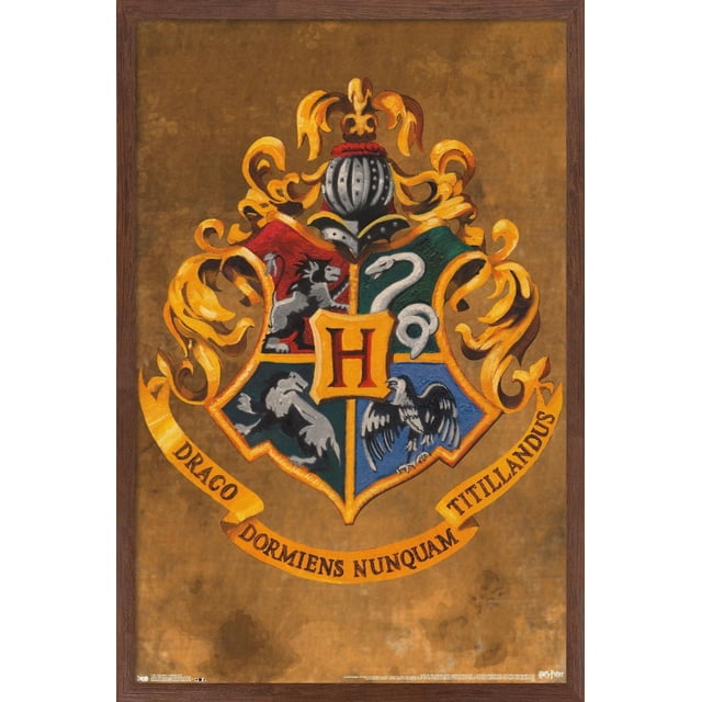 The Wizarding World: Harry Potter - Hogwarts Crest Wall Poster, 22.375" x 34" Framed features a centered Hogwarts crest with four quadrants showing a lion, snake, badger, and eagle on red, green, black, and blue backgrounds, topped by a knight's helmet and golden scrollwork on a textured brown backdrop with the motto 'Draco Dormiens Nunquam Titillandus' on a yellow banner, enclosed in a dark wood frame, suitable for wall art and home décor.