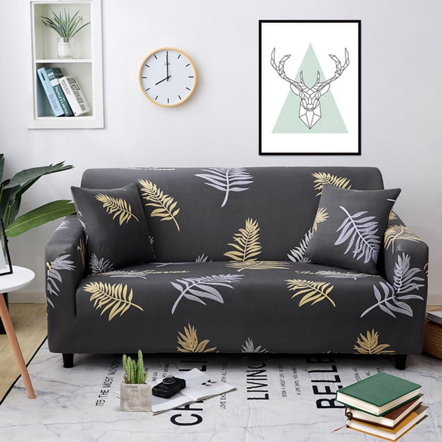 1/2/3/4 Seater Elastic Sofa Covers Slipcover Settee Stretch Floral Couch Protector in a living room setting. The cover has a dark grey base with yellow and white leaf patterns, made from durable polyester fiber. Designed for sofas sized 90 cm to 300 cm, it offers stretchable material for a snug fit, protecting against stains, pet hair, and wear. Ideal for home décor and events.