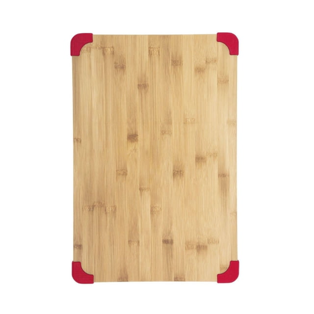 Farberware 12x18 inch cutting board made of natural bamboo with a rectangular shape, featuring red nonslip grips on each corner and a smooth surface, ideal for chopping and slicing in the kitchen.