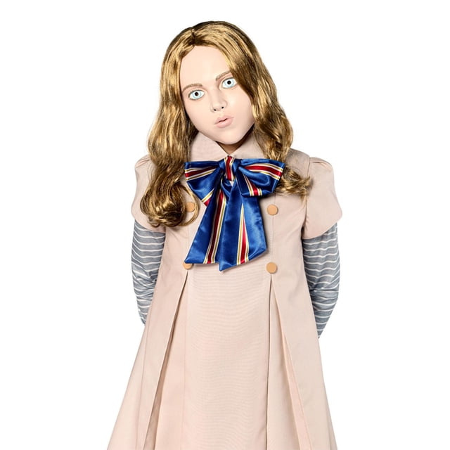 M3gan Adult Mask with a plastic vacuform design and attached long blonde hair styled in loose waves, shown with a beige double-breasted dress featuring four buttons and a large blue satin bow with red and yellow stripes, layered over a grey and white striped long-sleeve shirt.