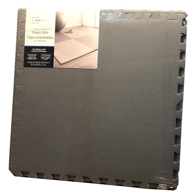 Mainstays Interlocking Foam Mat in dark grey with textured surface and puzzle-piece edges, folded with packaging label showing home workout use; provides anti-fatigue relief, shock absorption, and easy cleaning, ideal for custom floor coverage or play areas.