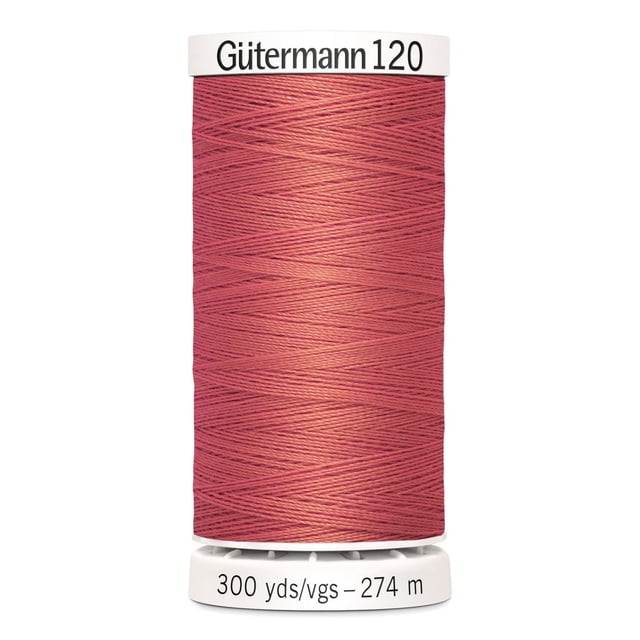 Gutermann 120 100% polyester all purpose thread spool in muted red, tightly wound on a white plastic spool marked with 300 yards (274 meters), suitable for machine and hand sewing various fabrics including cotton, synthetics, and craft projects like home décor and mending.