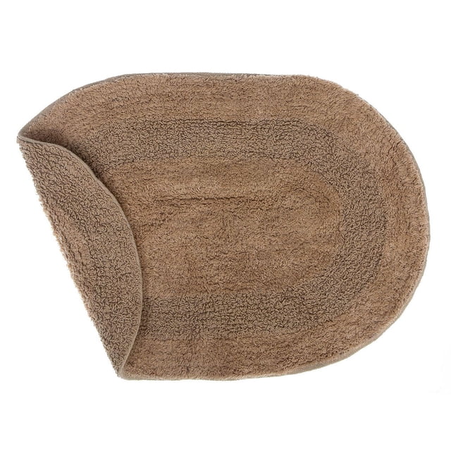 Reversible Cotton Oval Solid Color Bath Mat (16 X 24) (Taupe) with a taupe oval cotton bath rug showing looped texture and a flipped corner revealing its reversible design, suitable for bathroom floors on tile or hardwood to absorb water and reduce slipping.