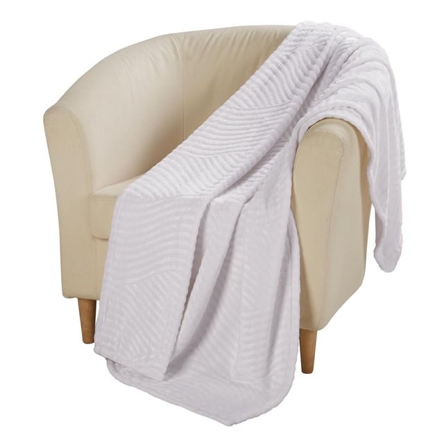 hometrends Luxury Plush Throw blanket draped over a beige tub chair, showing soft, textured white fabric with a subtle geometric pattern, ideal for adding warmth and comfort to living rooms or bedrooms and suitable for cozy reading or relaxing.