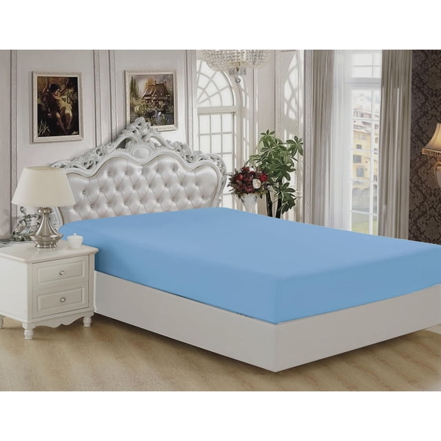 Marina Decoration Ultra Soft Silky Deep Pocket Solid Rayon from Bamboo All Season Bedding Solid Bamboo Fitted Sheet in blue color fitted on a bed with a white tufted ornate headboard, beside a white nightstand with lamp, in a bright room with large arched windows, floral arrangement, and wood flooring.