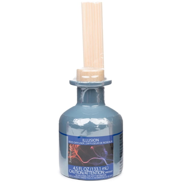 ScentSationals Reed Diffuser - Illusion with a 4.5 fl oz (133.1 mL) blue glass bottle, wooden cork, and eight beige reed sticks, an essential oil diffuser releasing cedar, musk, and fresh green aromatherapy scents, suitable for creating a relaxing home atmosphere.