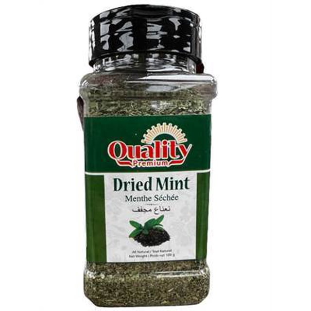 Quality Dried Mint 100G in a clear plastic jar with black screw-on lid, containing finely chopped dried mint leaves, labeled in green and white with multilingual text, suitable for seasoning and herbal culinary use.