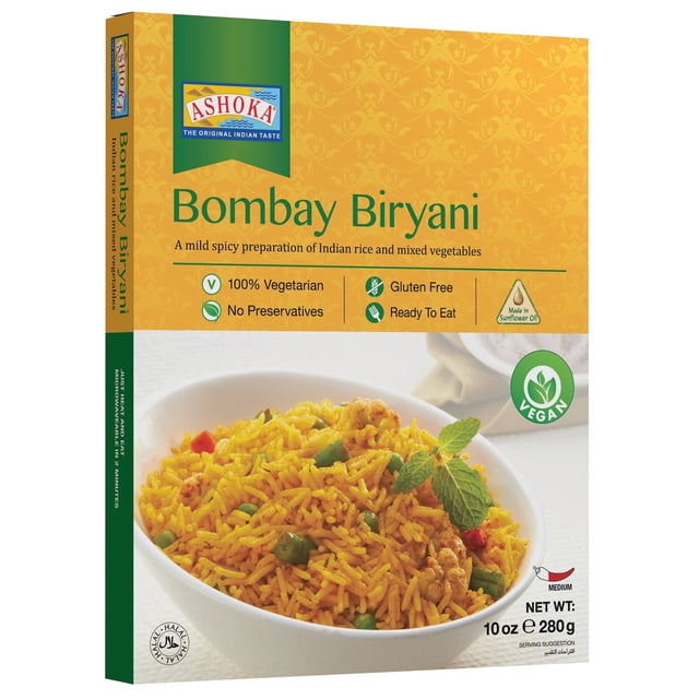 Ready to Eat - Bombay Biryani by Ashoka, 280g package showing a bowl of yellow Indian rice with mixed vegetables like peas and cauliflower, garnished with a mint leaf. This mild spicy Indian meal is 100% vegetarian, gluten-free, contains no preservatives, and is made with sunflower oil. Suitable for vegan diets and ready to eat.
