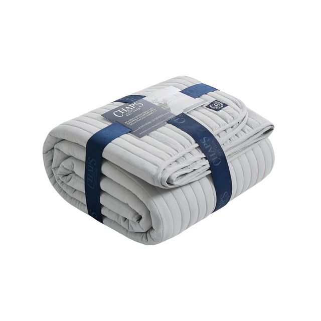 Chaps 3pc Quilt Set Grey King folded with navy blue branded straps, featuring a ribbed quilted texture in serene grey, designed for king-sized beds to enhance bedroom comfort and style, also suitable for layering in guest rooms.