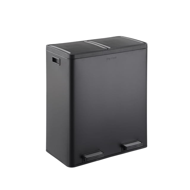 The Step N' Sort Large Capacity 70 L, 2 Compartment Trash and Recycling Bin in matte black with fingerprint-proof finish, shown from a 3/4 front angle. It features two removable 35 L inner bins for sorting trash and recycling, dual step pedals for hands-free lid opening, side handles, and a non-skid rubber bottom. Suitable for home or office use, it includes labels for easy waste separation and is easy to clean with soap and water.