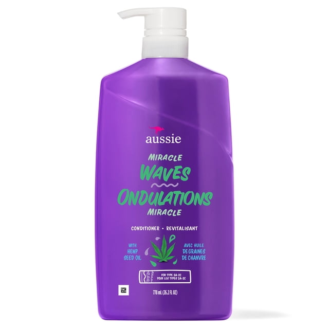 Aussie Miracle Waves Anti-Frizz Hemp Paraben-Free Conditioner in a purple pump bottle with green text and hemp seed oil graphic, formulated for wavy hair types 2A-2C, 778 ml (26.2 fl oz), designed to moisturize and reduce frizz.