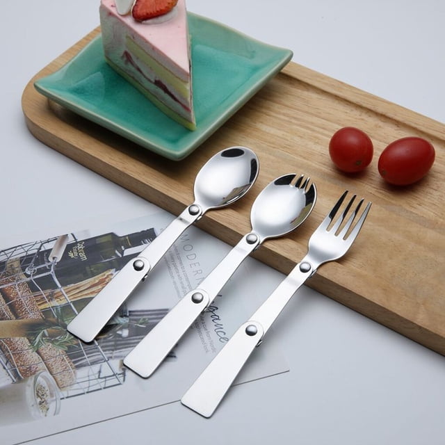 ruzhgo Stainless Steel Camping Cutlery Portable Washable Smooth Foldable Outdoor Flatware Tableware with Storage Case 1.2mm Spork Blue. A foldable stainless steel cutlery set featuring a spoon, fork, and spork, displayed on a wooden tray with a slice of cake and cherry tomatoes nearby. Ideal for camping, hiking, and picnics, this durable and portable flatware set includes a storage case for easy carrying.