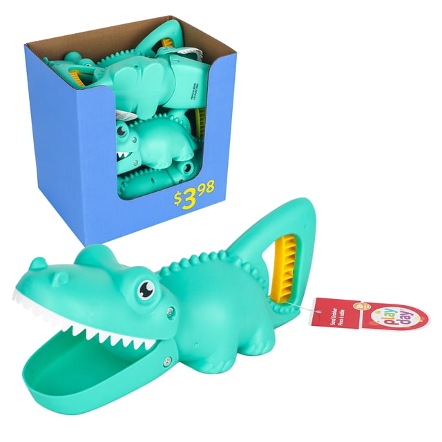 Animal Sand Scraper - Crocodile by Playday, a turquoise plastic sand and beach toy shaped like a crocodile with an open mouth and white teeth, featuring a yellow handle grip on the tail, shown inside a blue display box and separately on a white background, suitable for creative sandbox and beach play.