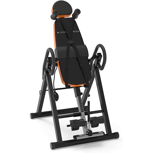 84 Acres FITNESS Inversion Table Pro with a 300 lbs weight capacity, featuring a soft-touch foam leather board for comfort, adjustable safety pin for positioning, and high-quality leg rollers and handlebars for secure inversion. The black and orange portable design accommodates users from 4ft-10in to 6ft-6in and includes a heavy-duty metal frame for stability.