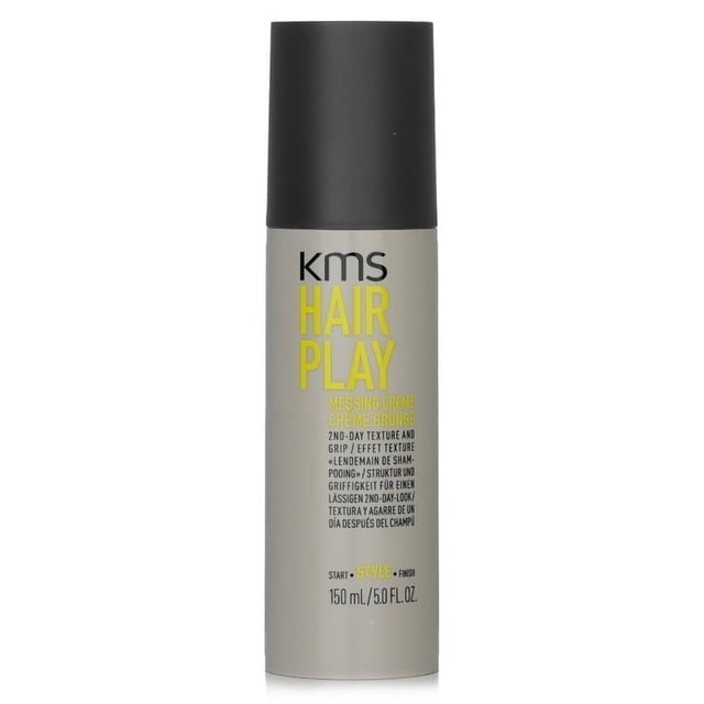KMS California Hair Play Messing Cream 150ml/5oz in a sleek cylindrical bottle with a grey body and black cap. The label features bold yellow and black text highlighting its purpose for creating second-day texture and a messy, lived-in look. Suitable for fine hair, it provides medium hold, workable grip, and grittiness. Free of parabens, gluten, mineral oil, and alcohol.