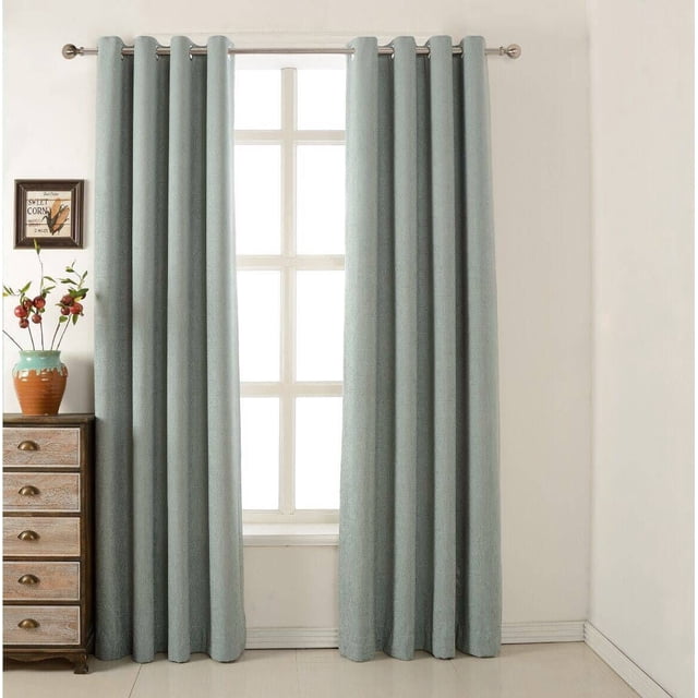 Gouchee Design Chenille Lined Panel in light blue with eight silver metal grommets, fully lined with soft fabric, hanging on a curtain rod in front of a window with white grid panes, next to a wooden dresser with a ceramic vase of red berries and framed wall art on a cream wall, ideal for room darkening and adding texture.