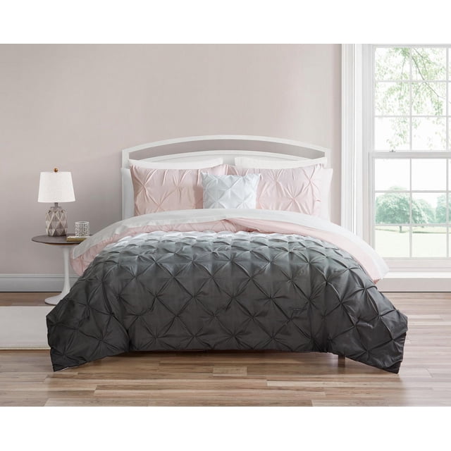 Martina 8 Piece Bed in a Bag with a front-facing bed dressed in a microfiber comforter showing charcoal gray to white to light pink ombre and kiss pleat texture, two light pink shams, a white decorative pillow with pleats, and a white microfiber sheet set, in a softly lit bedroom with a side table and window, ideal for easy machine washing and care.