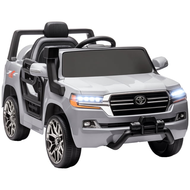 Qaba 12V Electric Car for Kids, a licensed Toyota LAND CRUISER ride-on toy in grey. Features include built-in songs, USB port, FM radio, horn, and two headlights for realistic play. Designed for children aged 37-72 months, it offers manual driving or remote control by parents. The car has a 12V dual motor, spring suspension, and adjustable speeds for a smooth ride. Dimensions are 42.1 inches long, 25.6 inches wide, and 21.9 inches high.