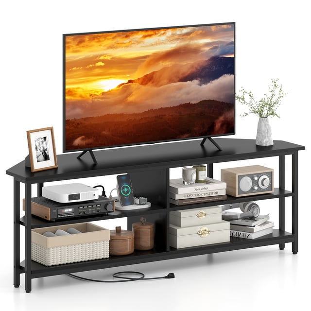 Giantex Nightcore Corner TV Stand, a black entertainment center designed for TVs up to 65 inches. Features a 3-tier open shelving system for media devices, books, and decor. Includes a built-in charging station with 2 AC outlets, 1 USB port, and 1 Type-C port. Constructed with a durable metal frame and adjustable foot pads for stability. Shown in a modern living room setup with a TV, decor items, and electronics neatly organized.