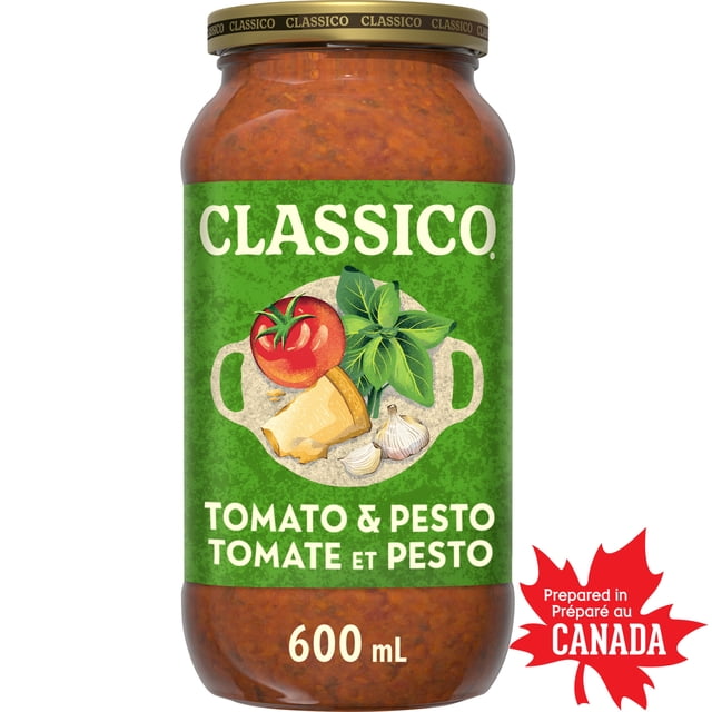 Classico Tomato & Pesto Pasta Sauce 600 mL jar with a green label featuring illustrations of tomato, basil, Parmesan cheese, and garlic, prepared in Canada, ideal for pasta, pizza, and meatball subs.