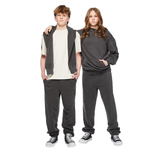 Jackson Boys' Washed Short Sleeve Crew Neck Tee in off-white knit jersey fabric worn by a boy standing beside a girl in dark grey oversized hoodie and sweatpants, both wearing black and white sneakers, shown in a front-facing full-body view on a white background, suitable for casual boys' tops.