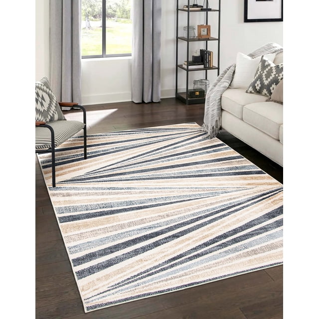 ECARPET Axel Contemporary/Modern Area Rug with abstract striped pattern in beige, blue, and gray tones, placed on dark hardwood floor in a living room with a beige sofa, patterned pillows, gray throw blanket, black metal chair with geometric cushions, and black metal shelving near a window with gray curtains. Suitable for living rooms, bedrooms, dining rooms, and hallways.