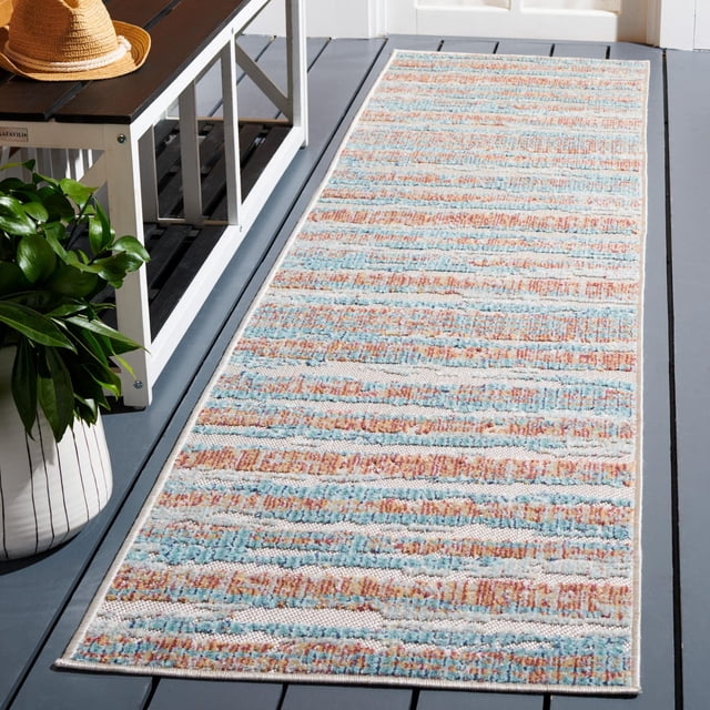 SAFAVIEH Cabana Gaila Abstract Indoor/Outdoor Area Rug rectangular runner with textured horizontal stripes in muted blue, orange, and cream colours, placed on a grey wooden porch floor beside a white bench with a straw hat and green plant, made from durable synthetic yarns resistant to weather and sun fading, suitable for busy indoor or outdoor spaces.
