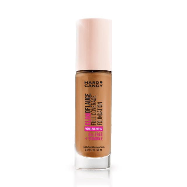 Hard Candy Glamoflauge Full Coverage Foundation, 1512 Warm Honey, in a clear glass bottle with a pale pink cap. This hydrating, medium coverage liquid foundation offers 16-hour wear with a matte finish. It is lightweight, breathable, transfer-proof, water-resistant, and oil-free with vitamin E, ideal for long-lasting, even coverage.