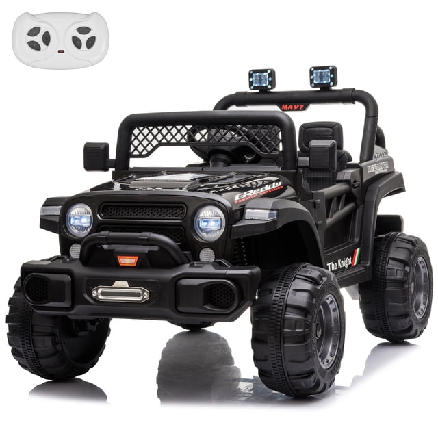 VOLTZ TOYS Jeep 12V Kids Ride On Car Toy with Open Doors, Working Searchlights, Parental Remote Control & LED Headlights - Black front-facing view of a black Jeep-style 12V ride-on with openable doors, visible grille and high-clearance frame, LED headlights and overhead searchlights lit, single molded seat and wide traction wheels, 2.4G parental remote control included, built-in music player on the dashboard, 12V battery and dual rear motors as product features, seating for one child ages 3–8; often used as a playroom prop for pretend driving.